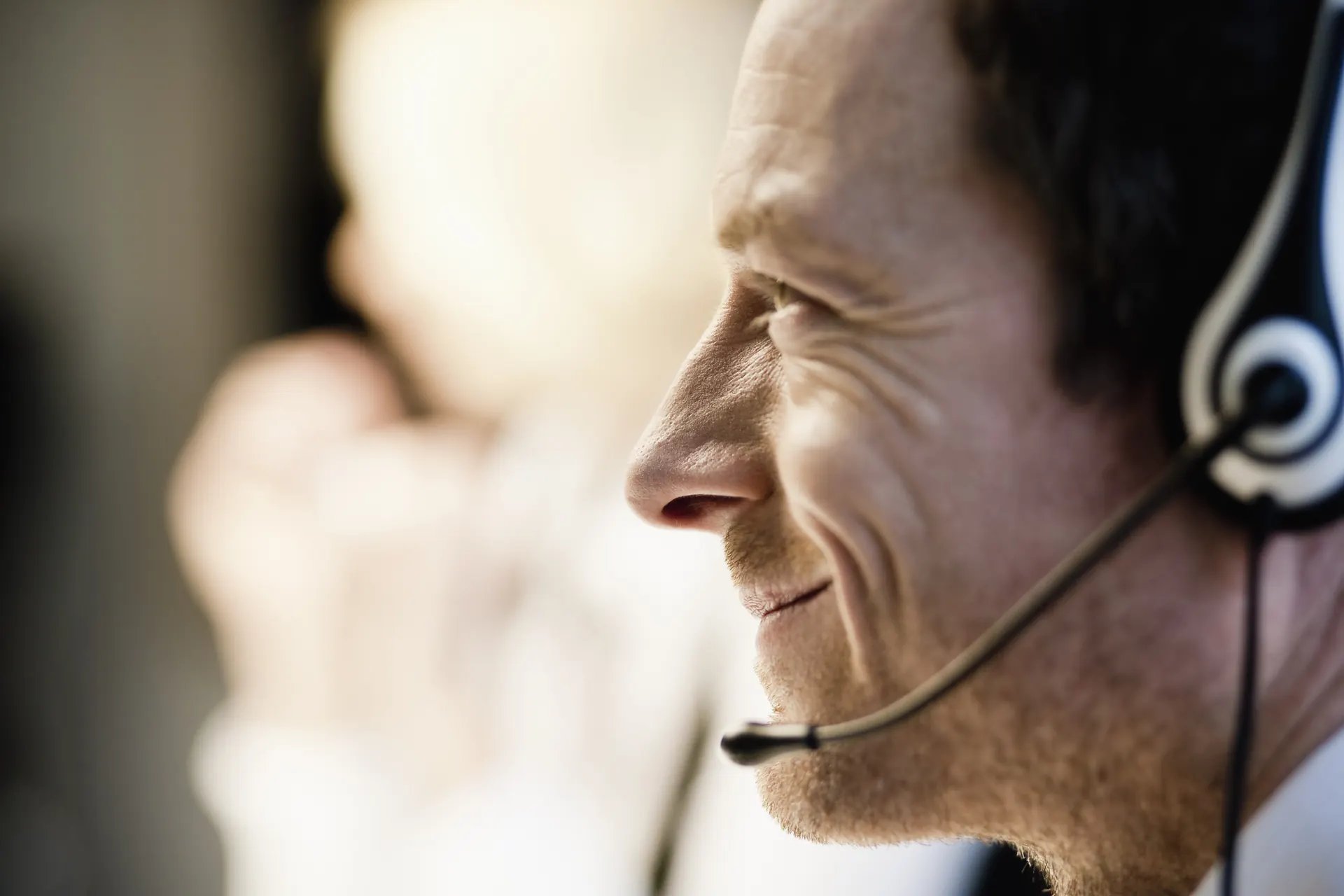 Dream Travel advisor on the phone with a headset answering booking requests